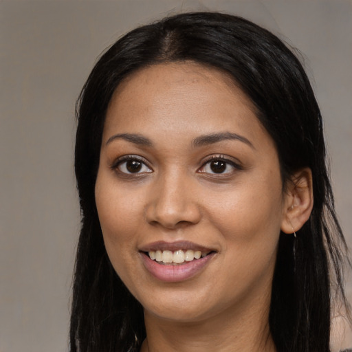 Joyful latino young-adult female with long  black hair and brown eyes