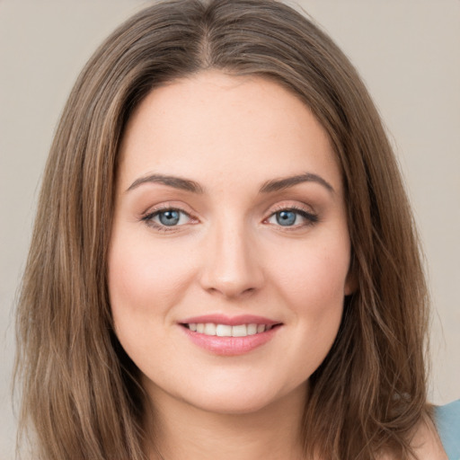 Joyful white young-adult female with long  brown hair and green eyes