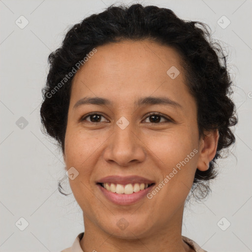 Joyful latino adult female with short  brown hair and brown eyes