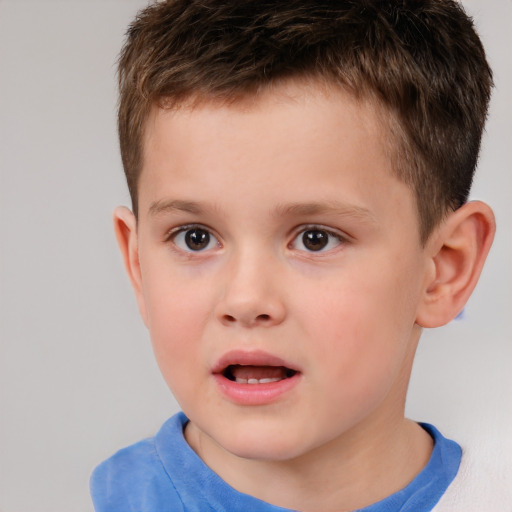 Joyful white child male with short  brown hair and brown eyes