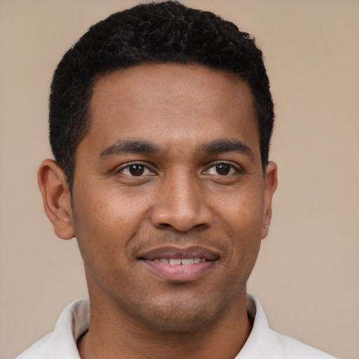 Joyful latino young-adult male with short  black hair and brown eyes
