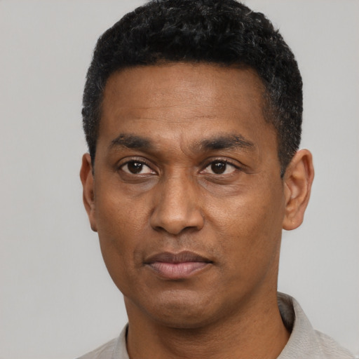 Neutral latino adult male with short  black hair and brown eyes