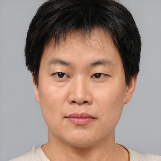 Neutral asian young-adult male with short  brown hair and brown eyes