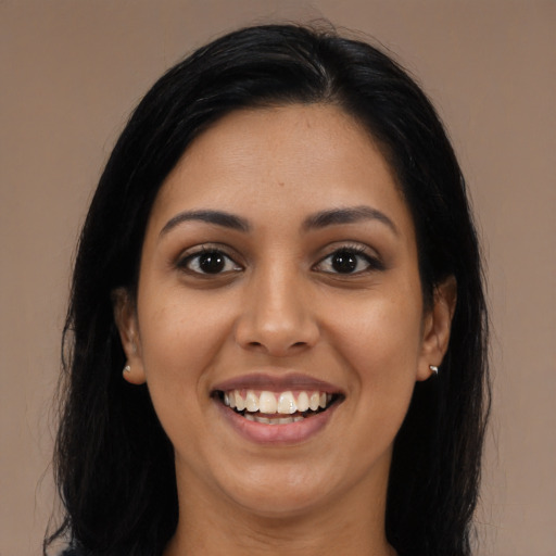 Joyful latino young-adult female with long  black hair and brown eyes