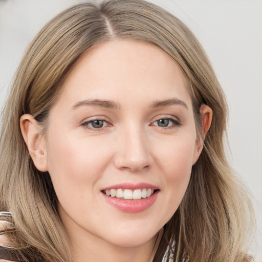 Joyful white young-adult female with long  brown hair and grey eyes