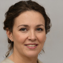 Joyful white adult female with medium  brown hair and brown eyes