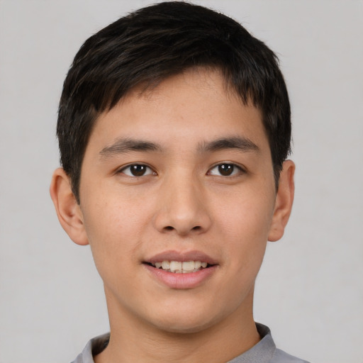 Joyful asian young-adult male with short  black hair and brown eyes