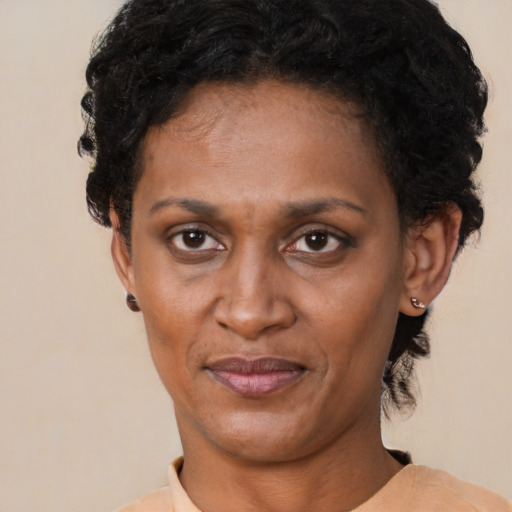 Joyful latino adult female with short  black hair and brown eyes