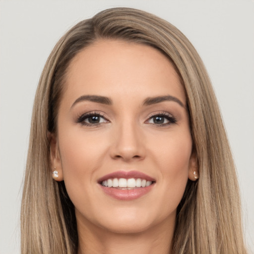 Joyful white young-adult female with long  brown hair and brown eyes