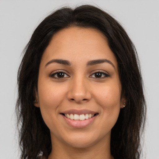 Joyful latino young-adult female with long  brown hair and brown eyes