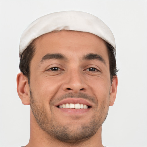 Joyful white young-adult male with short  brown hair and brown eyes