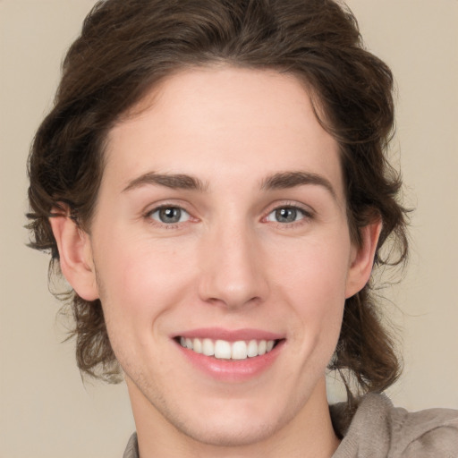 Joyful white young-adult female with medium  brown hair and green eyes