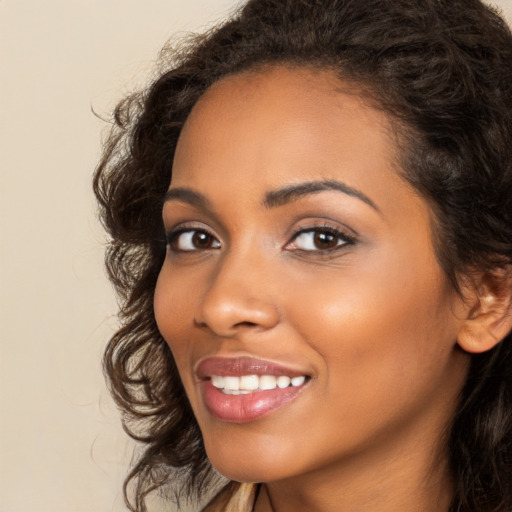 Joyful latino young-adult female with long  brown hair and brown eyes