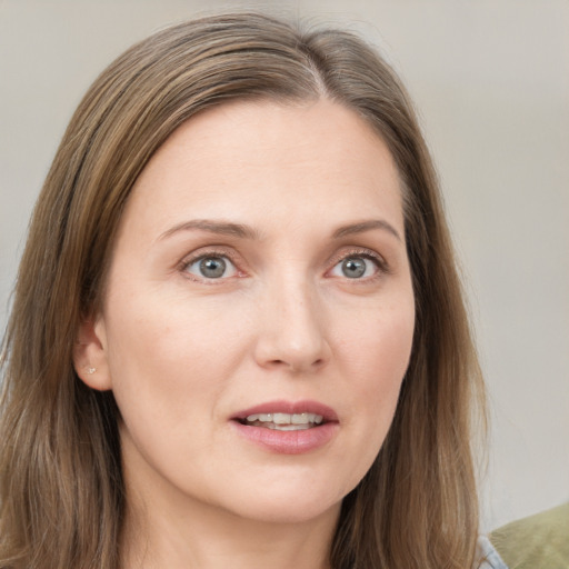 Joyful white young-adult female with long  brown hair and grey eyes