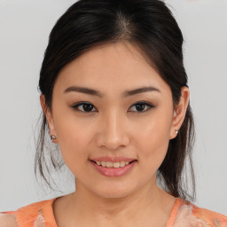 Joyful asian young-adult female with medium  brown hair and brown eyes