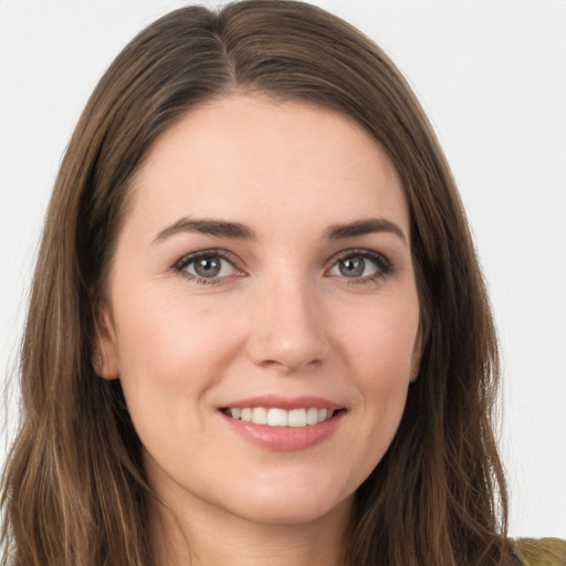 Joyful white young-adult female with long  brown hair and brown eyes