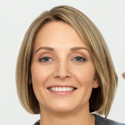 Joyful white young-adult female with medium  brown hair and blue eyes