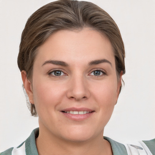 Joyful white young-adult female with short  brown hair and grey eyes