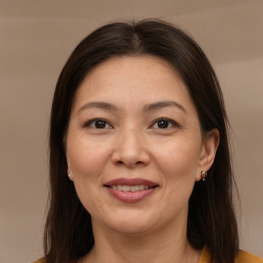 Joyful white adult female with medium  brown hair and brown eyes