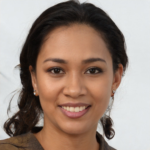 Joyful latino young-adult female with medium  brown hair and brown eyes