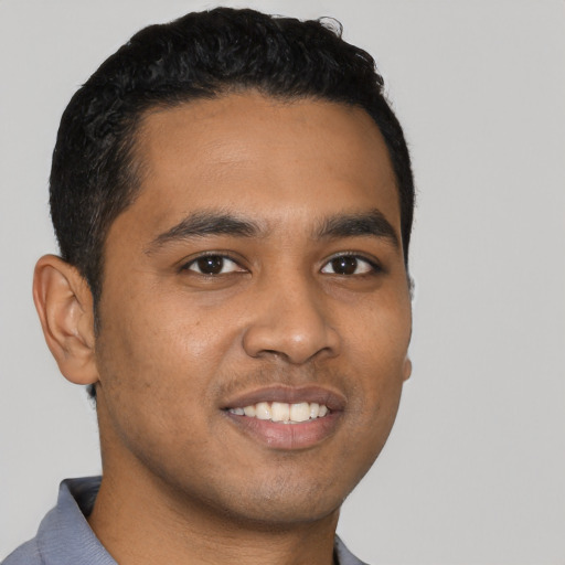 Joyful latino young-adult male with short  black hair and brown eyes
