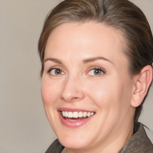 Joyful white adult female with medium  brown hair and brown eyes