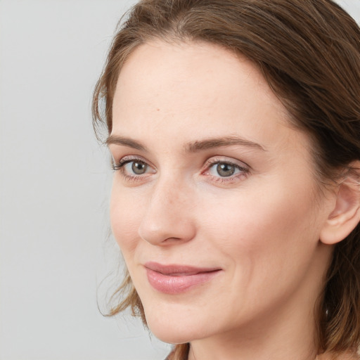 Joyful white young-adult female with long  brown hair and grey eyes