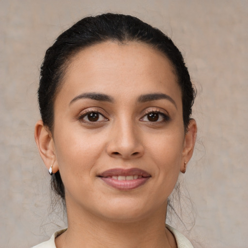 Joyful latino young-adult female with short  brown hair and brown eyes