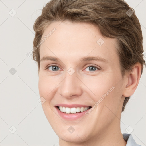 Joyful white young-adult female with short  brown hair and grey eyes