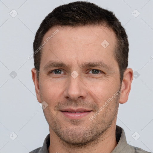 Joyful white adult male with short  brown hair and brown eyes