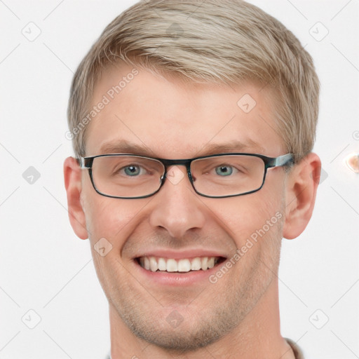 Joyful white adult male with short  brown hair and blue eyes