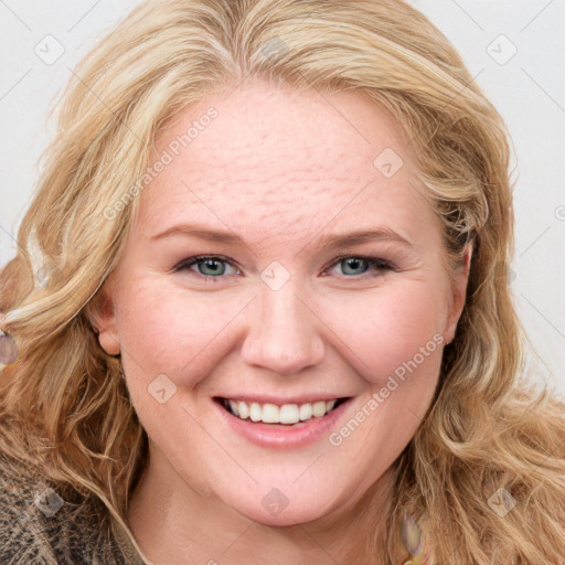 Joyful white young-adult female with long  brown hair and blue eyes