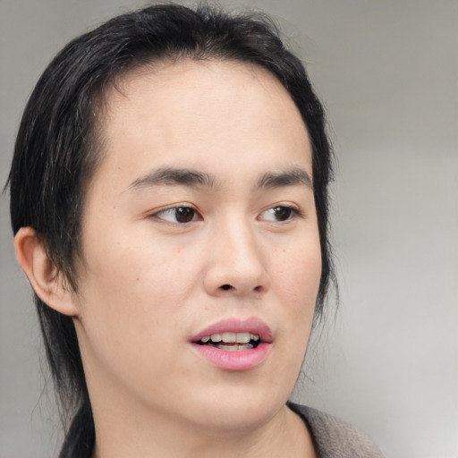 Joyful asian young-adult male with medium  black hair and brown eyes
