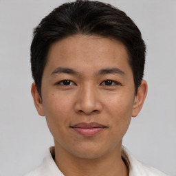 Joyful asian young-adult male with short  brown hair and brown eyes