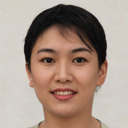 Joyful asian young-adult female with short  brown hair and brown eyes