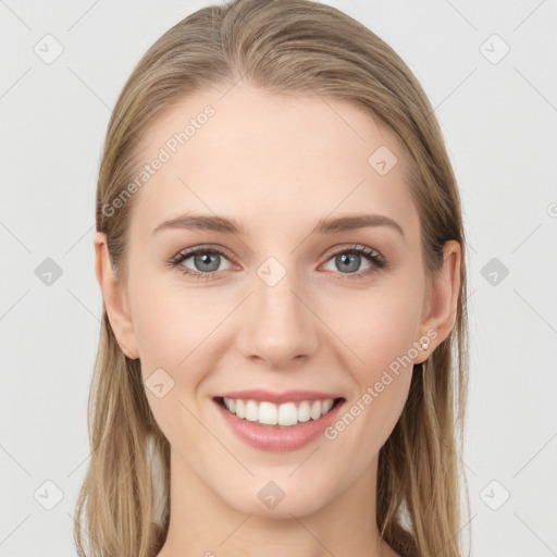 Joyful white young-adult female with long  brown hair and grey eyes