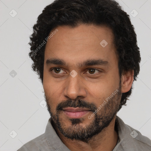 Joyful black adult male with short  black hair and brown eyes