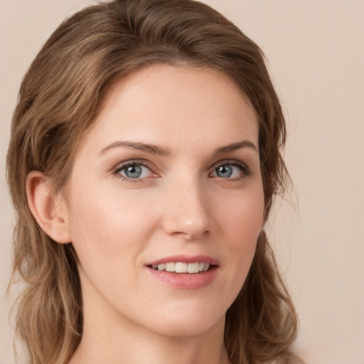 Joyful white young-adult female with long  brown hair and grey eyes