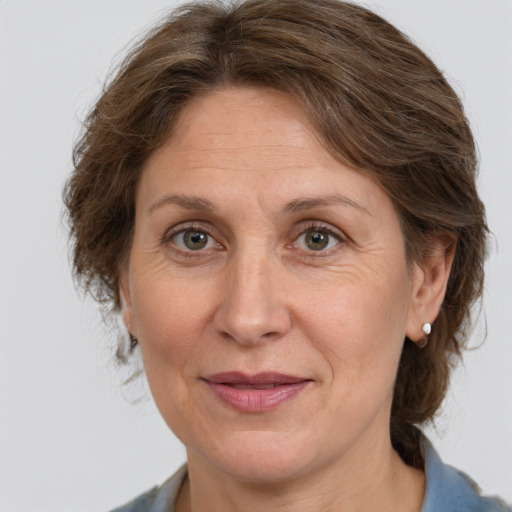 Joyful white adult female with medium  brown hair and grey eyes