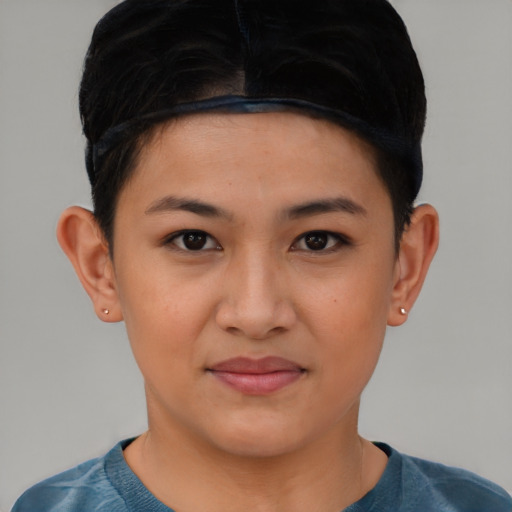 Joyful latino young-adult female with short  black hair and brown eyes