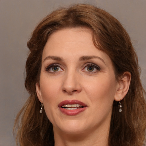 Joyful white adult female with long  brown hair and brown eyes