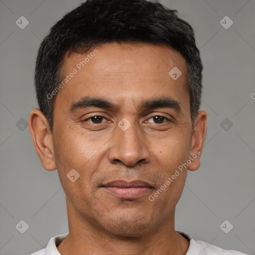 Joyful latino adult male with short  black hair and brown eyes