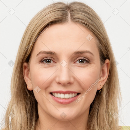 Joyful white young-adult female with long  brown hair and brown eyes