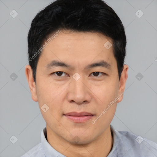 Joyful asian young-adult male with short  black hair and brown eyes