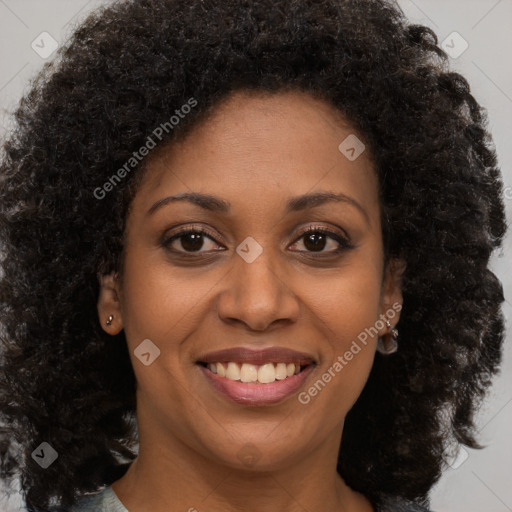 Joyful black young-adult female with long  brown hair and brown eyes