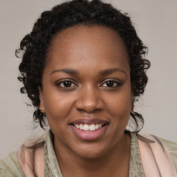 Joyful black young-adult female with long  brown hair and brown eyes