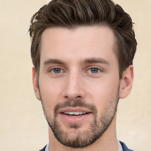 Joyful white young-adult male with short  brown hair and grey eyes