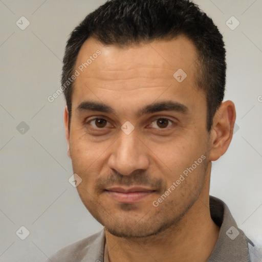 Joyful white young-adult male with short  black hair and brown eyes