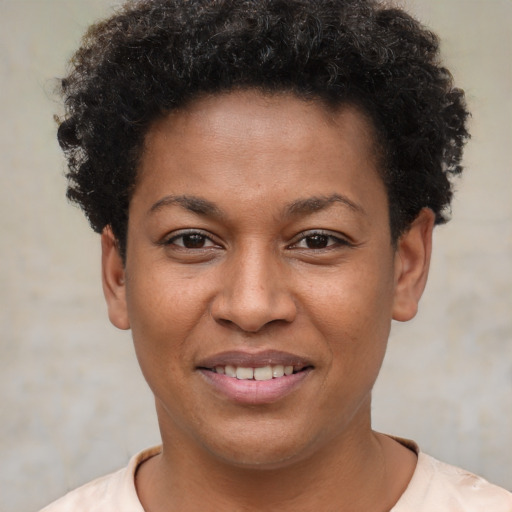 Joyful black young-adult female with short  brown hair and brown eyes