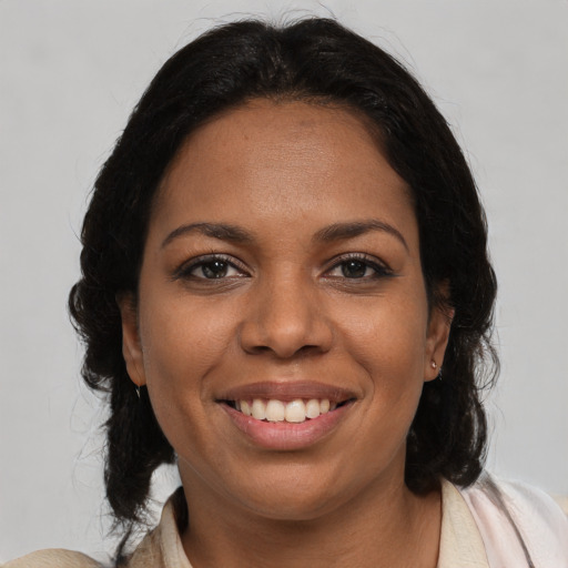 Joyful black adult female with medium  brown hair and brown eyes